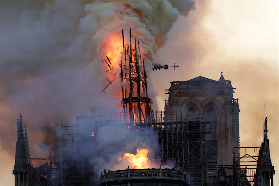 A photo of the fire that devastated the Notre Dame Cathedral in Paris, just as the spire falls.